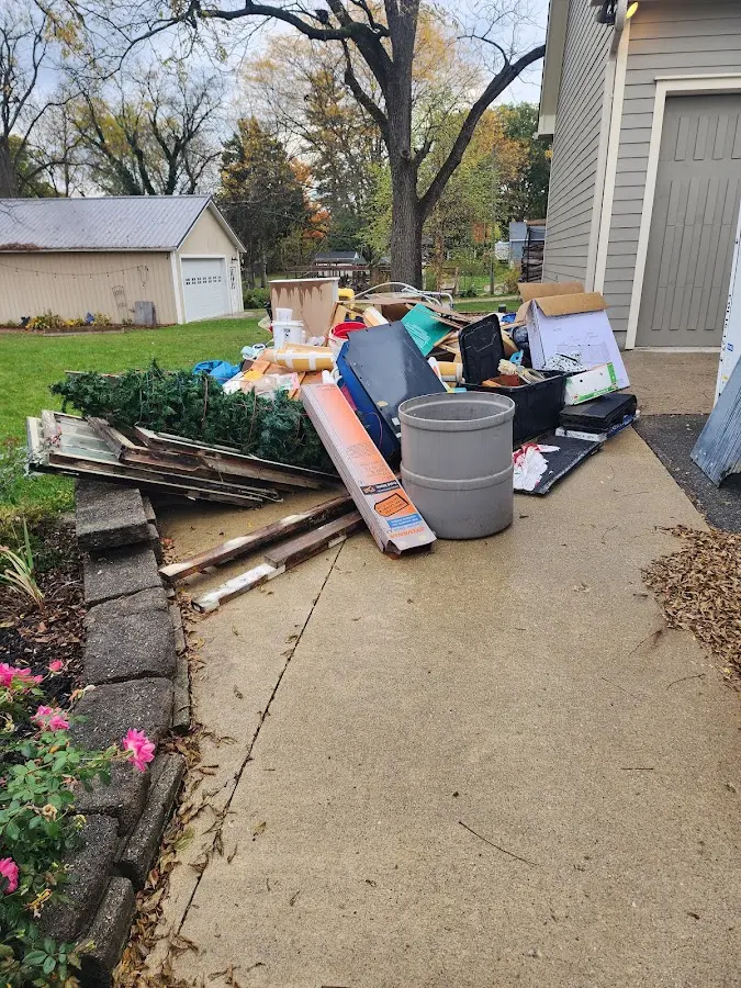 Dumpster being loaded with debris for 12 Yard Dumpster Rental in Delphos